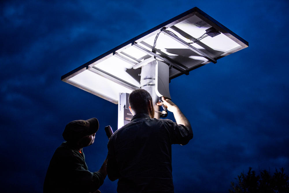 Two men setting up camera