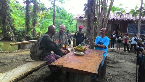 Alex Waisimon sitting at an outside table with a group