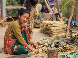 Juni Maya Bhujel making brooms at her house.