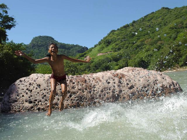 Child jumping into the water.