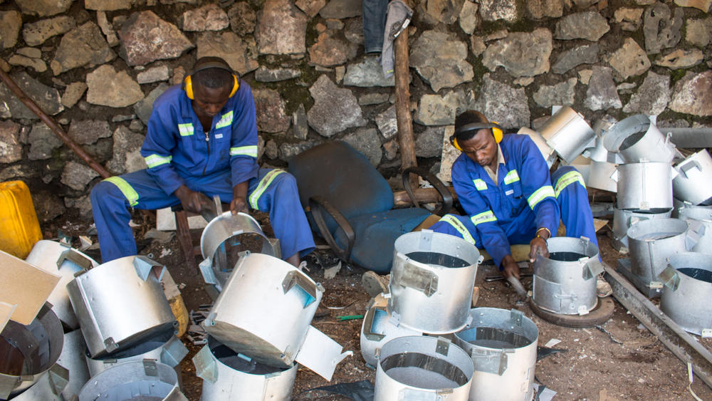 Workers shape the tin stoves