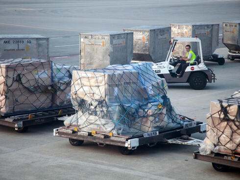 Baggage is moved across the tarmac at an airport. 