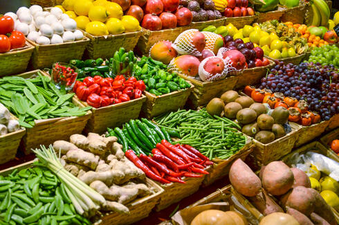 Large display of several rows of fruits and vegetables 