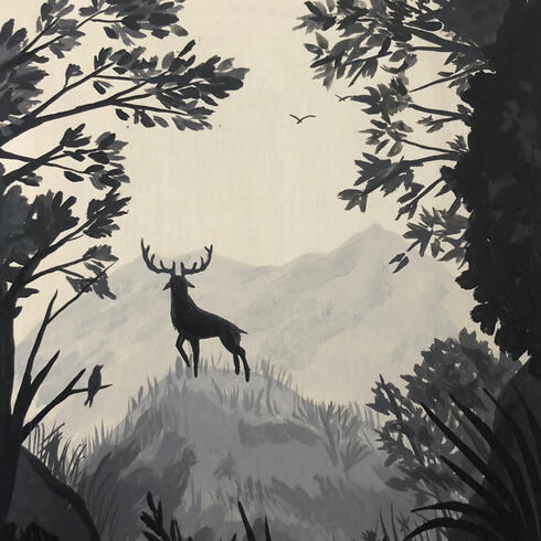 Silhouette of deer on hill with trees