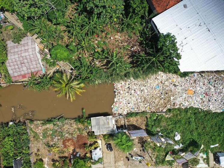 Aerial photo of a river clogged by plastic waste