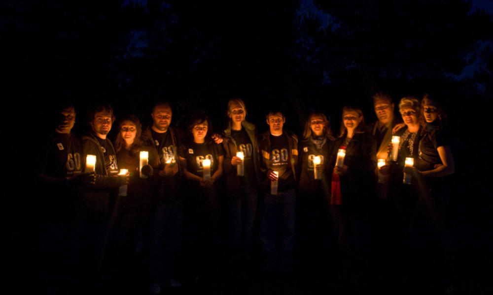 People holding candles during earth hour