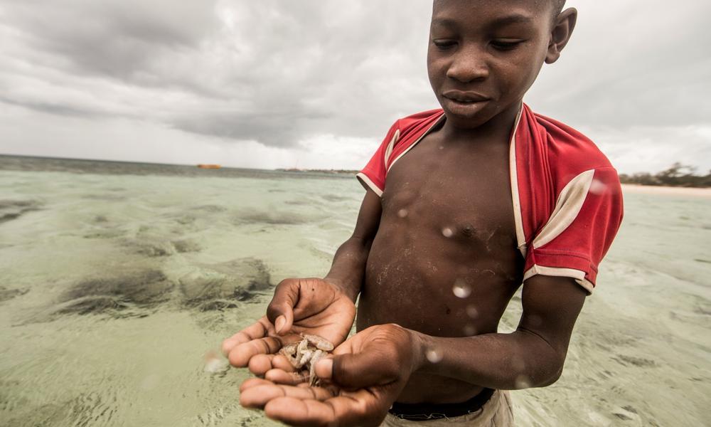 A Nuarro boy shows off his method for catching fish