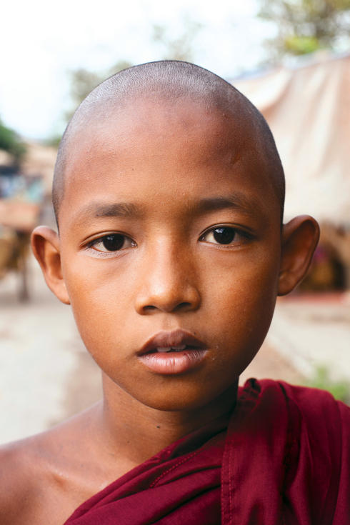 A young Buddhist monk in the ancient city of Bagan. Nearly 90% of Burmese identify themselves as adherents to the Buddhist faith.
