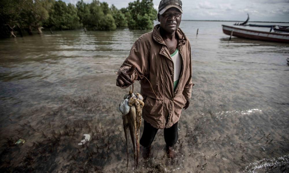 Fisherman shows off his octopus catch.