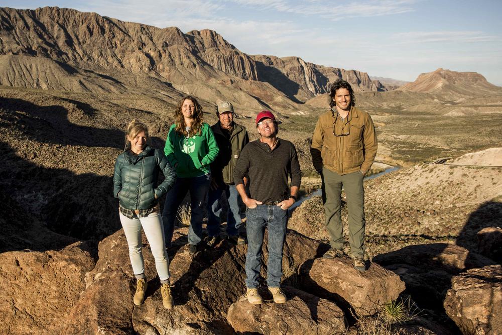 Nate and Morgan stand with WWF staff members above the Rio Grande.
